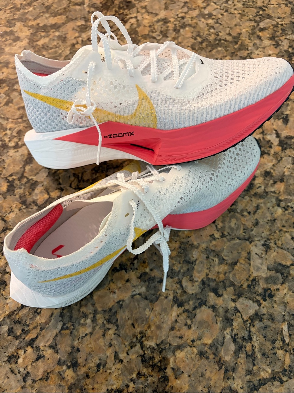 Nike Women’s White Vaporfly Running Shoes with Pink Midsole and Yellow Swoosh